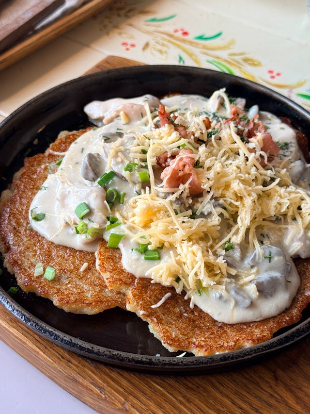 A photo of a plate with fried potato pancakes